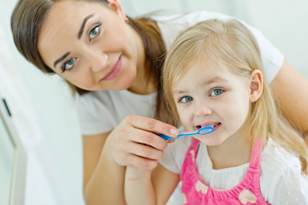 Mom and Daughter brushing their teeth - Pediatric Dentist in Gulfport, MS